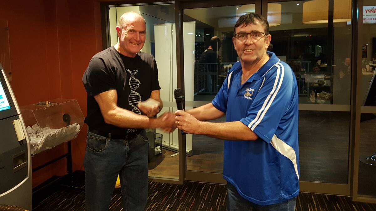 HELPING HAND: Andy Johnson from the Tathra Mountain Bike Club is presented with $500 by Bega Bowlo Fishing Club president Barry Blacka.