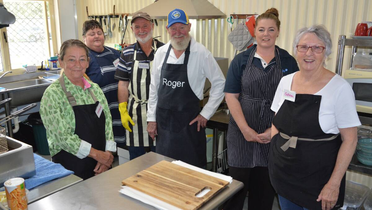 Volunteers in the Bemboka Sports, Social and Recreation Club kitchen on Tuesday are (from left) Lorna, Anna Rheinberger, Duncan McPaul, Roger Van Cornewal, Bec Inskip and Colleen Van Cornewal. Picture by Ben Smyth