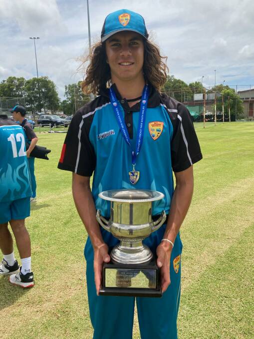 CUP GLORY: Eden cricketer Rahul Mudaliar, 15, with the Bradman Cup he helped his ACT/Southern side win last week in Newcastle. Photo: Supplied