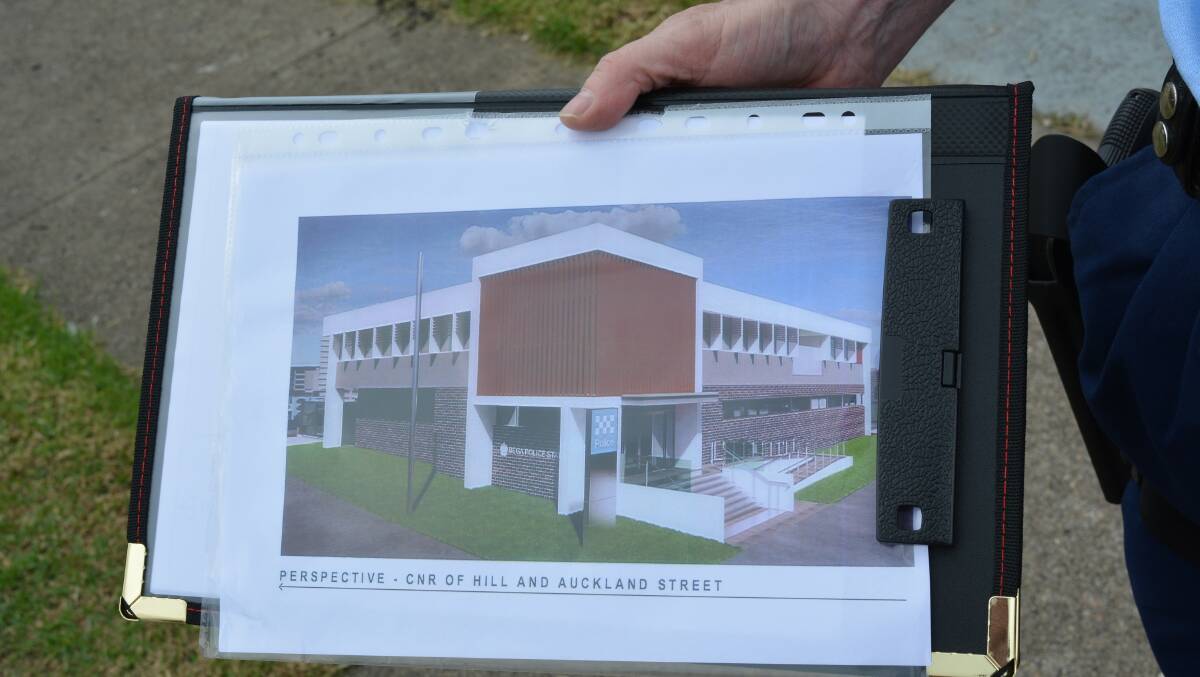 Superintendent Greg Moore shows off some concept art of what the new police station will look like. Photo: Ben Smyth