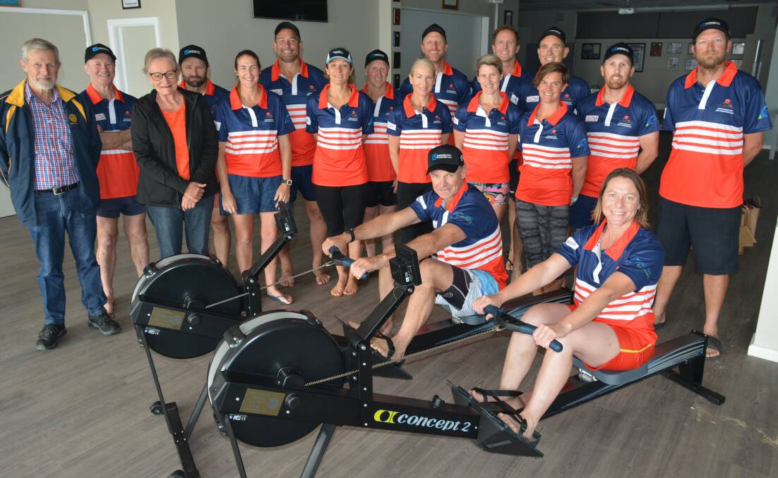 Charlie Bloomfield and Margaret Taylor present new rowing machines from Bega Rotary and Tathra Lions to the Tathra Surf Club's veteran rowers. Photo: Ben Smyth