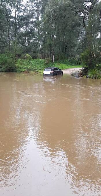 A driver became stuck attempting to navigate the flooded river crossing at Little Glen Oaks Road, Greendale.