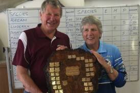 Terry Carson of Eden Amateur Fishing Club presents the Grudge Match Shield to Merrily Bell on behalf of Merimbula Big Game and Lakes Angling Club.