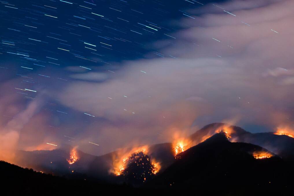 Fire rages in the hills outside Bemboka during August and September. Picture: Helmut Eder