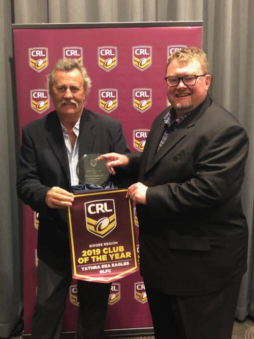 Tathra Sea Eagles Rugby League Football Club president Peter Finucane and secretary David Porter accept the CRL Club of the Year award on Saturday night.