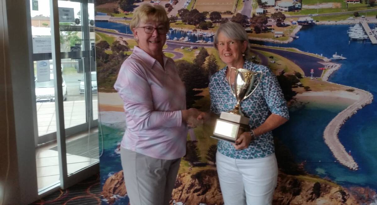 Captain Jo Buttrey presents Maggie Hayes with the Club Champions Trophy.