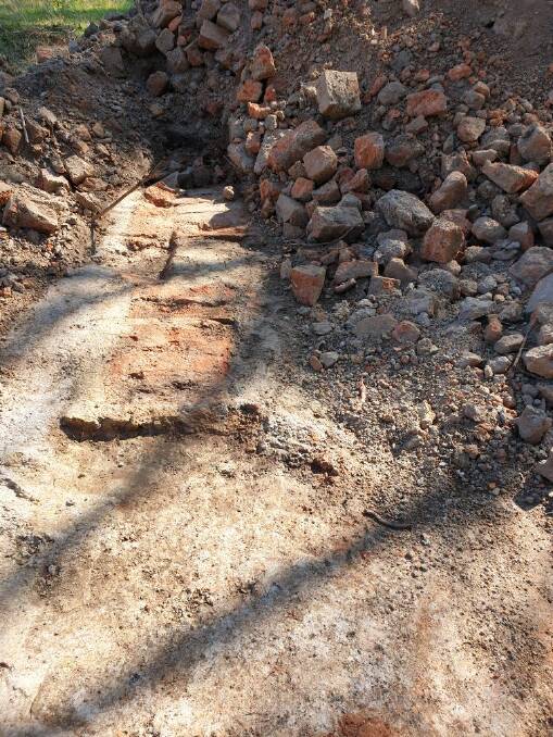 Brick foundations and rubble has been uncovered during the construction of the Tathra to Kalaru bike path. Photo: Margaret Evans