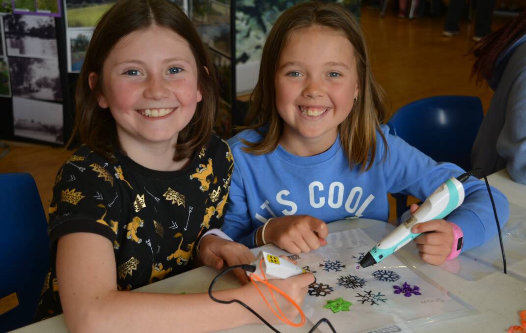 Maddison Harris and Taya Child create 3D designs with printing pens.