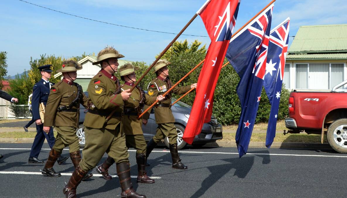 ON THE MARCH: Members of the 7th Light Horse Bemboka troop carry the flags at their home town's Anzac Day service on Wednesday. Picture: Rachel Helmreich