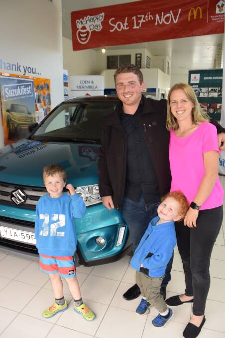 Josh and Naomi Shoobridge with two of their children take ownership of a new car after winning the prize in McDonald's Monopoly.