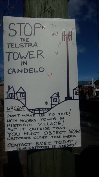 A sign tacked to a power pole in Candelo