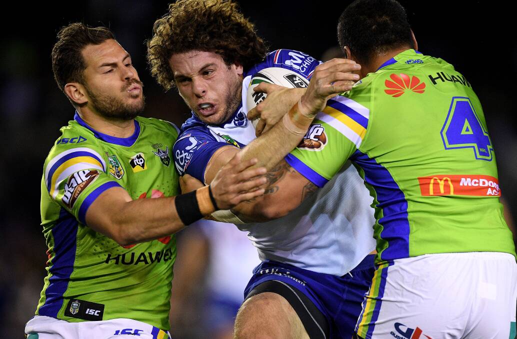 Canterbury's Adam Elliott is tackled by Canberra Raiders players during a match in July 2018. Picture: AAP/Dan Himbrechts
