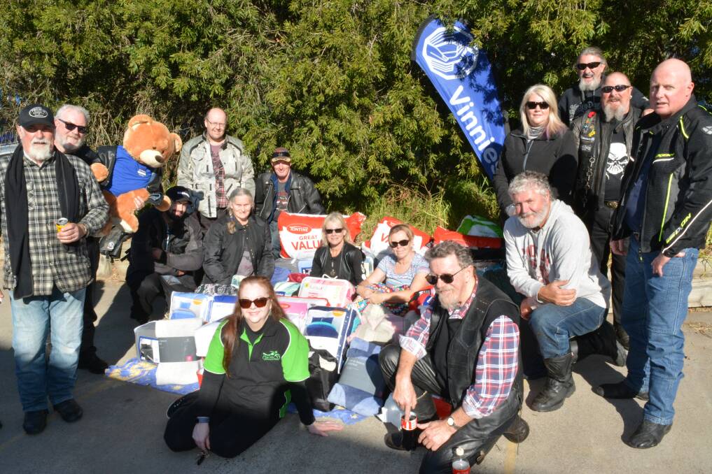 WARM-HEARTED: Motorcyclists drop by Bega Vinnies on Saturday with a huge collection of warm blankets and clothes. 