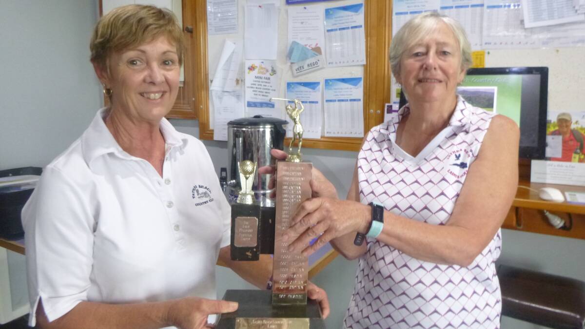 It's President's day: Tathra Ladies golf president Sue Howland accepts the matchplay trophy from captain Wendy Rhodes following her team's victory on Tuesday.