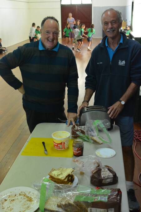 Social Justice Advocates Gavin Bell and Mick Brosnan prepare breakfast for the youth participants.