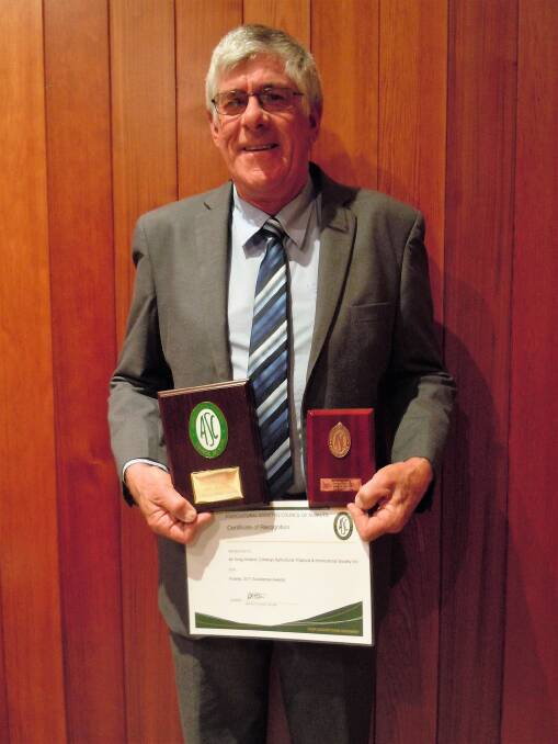 EXCELLENCE: Cobargo's Greg Holland proudly displays his excellence award from the Agricultural Societies Council of NSW.