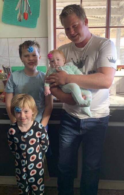 HARD-WORKING DAD: Lochiel dairy farmer Stuart Whitby with his three children, Billi, Rosie and Izzy. Photos: Supplied