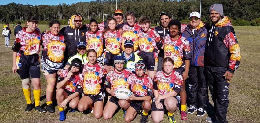 PRIDE: The Yuin Ducks under 16 girls team celebrate their Nations of Origin debut with coaches and mentors.