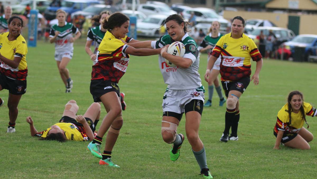 Cobargo's Millie Boyle fends off an Indigenous All Star during one of Group 16's feature women's contact rounds earlier in 2018.