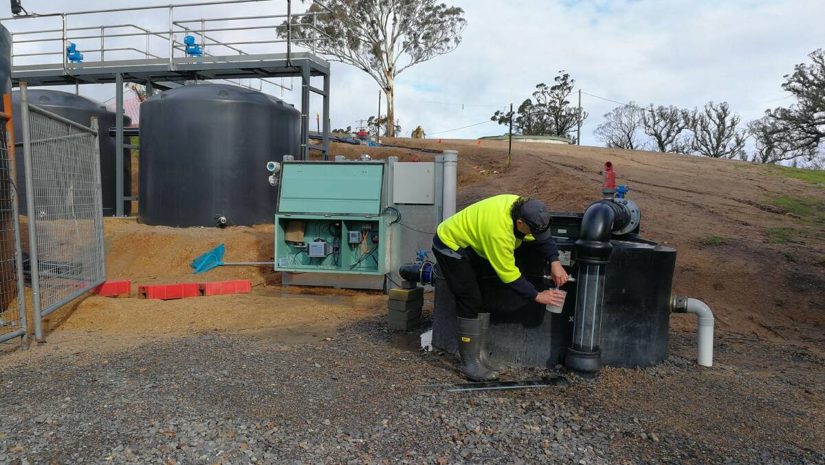 Councils W&SS operator Paul Lazarro samples water at the temporary settling plant at Upper Brogo.