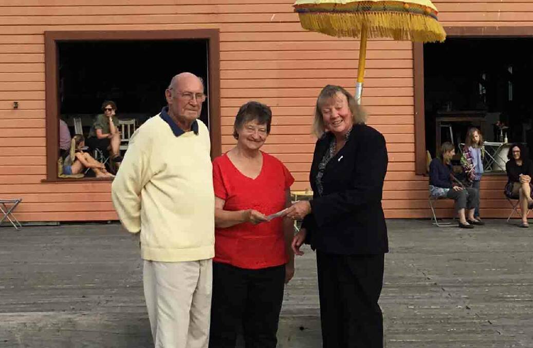 Yuin Folk Club committee members Graeme Fryer and Coral Vorbach present a cheque for $1285 to Deputy Mayor  Liz Seckold for the Tathra bushfire Mayoral Appeal Fund. 