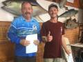Ben Thelan of Tathra, winner of the Merimbula Snapper Classic, receives the $600 cash prize for his magnificent 73.8cm snapper from club vice-president Alan Wilkins.