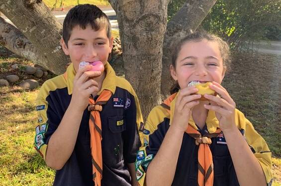 SWEET: Cobargo Cub Scouts Sean and Bella Walker get some doughnut eating practice.