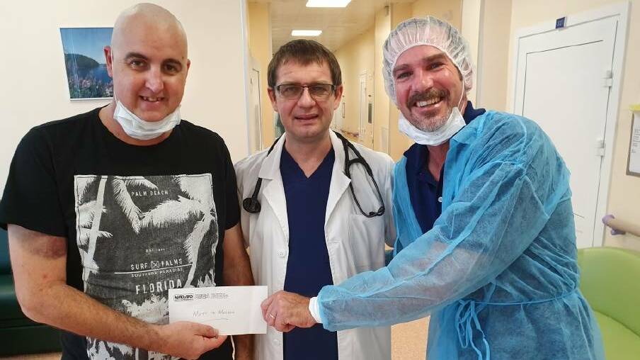 Steve Parker (right) visits Matthew Taylor in Moscow to help bring him home as well as hand over the collection from an AutoPro fundraising effort. They are pictured with Dr Denis Fedorenko.
