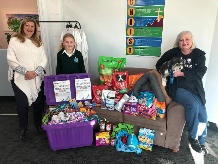 Evie Umbers and the collection she organised pictured with SCAC principal Tracey Gray and Kerri Brady, president of the Animal Welfare League (and her dog Norbert).