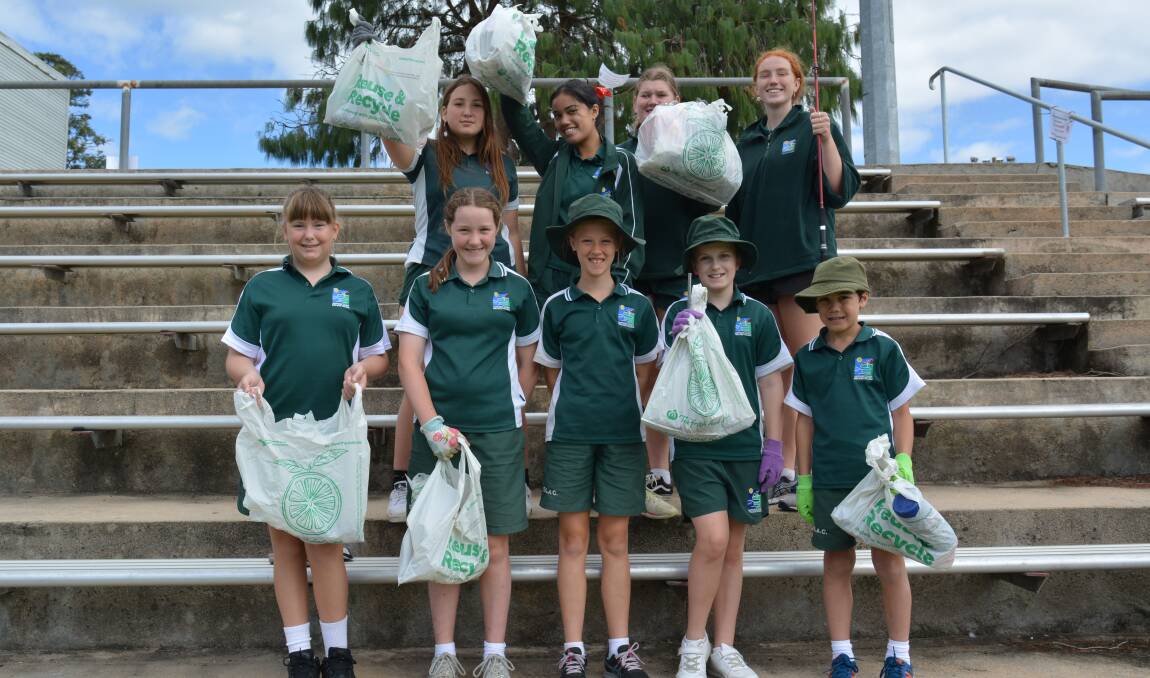 The young members of SPEC - the Save Planet Earth Club - from Sapphire Coast Anglican College collect rubbish at the Bega Rec Ground. Photo: Amandine Ahrens