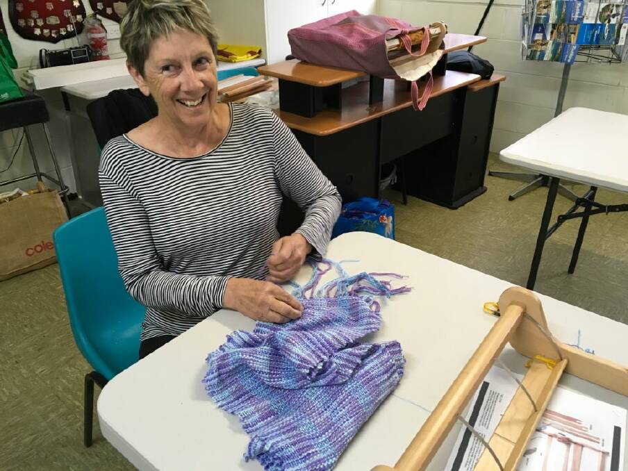 WARM THOUGHTS: Suzanne Simon puts the finishing touches on her weaving effort during a workshop in Tathra on Saturday.