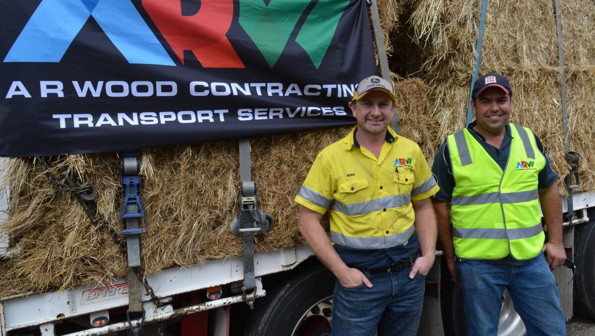 Drivers Russell Wood and Jon Green arrive as part of a three-truck delivery of donated hay from Mitta Valley for cattle farmers in the Bega Valley.