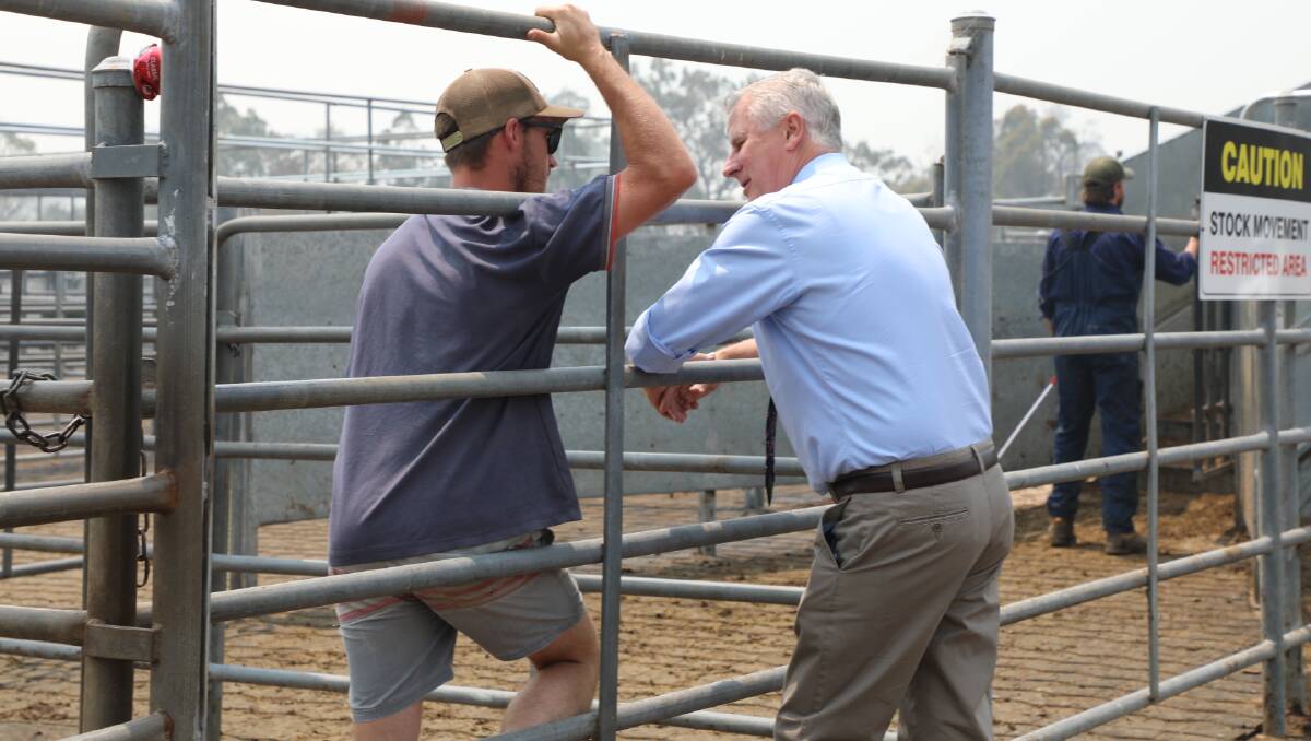 Acting Prime Minister Michael McCormack chats with farmers at the Bega Saleyards on Wednesday, December 18.
