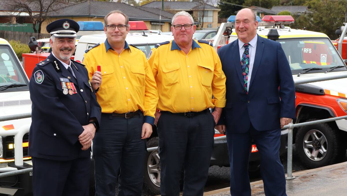 NSW RFS Superintendent Angus Barnes and Bega Valley Mayor Russell Fitzpatrick hand over the keys to a new truck for the Eden Brigade to Senior Deputy Captain Jeffrey Whiter and Deputy Captain Robert Aucote.