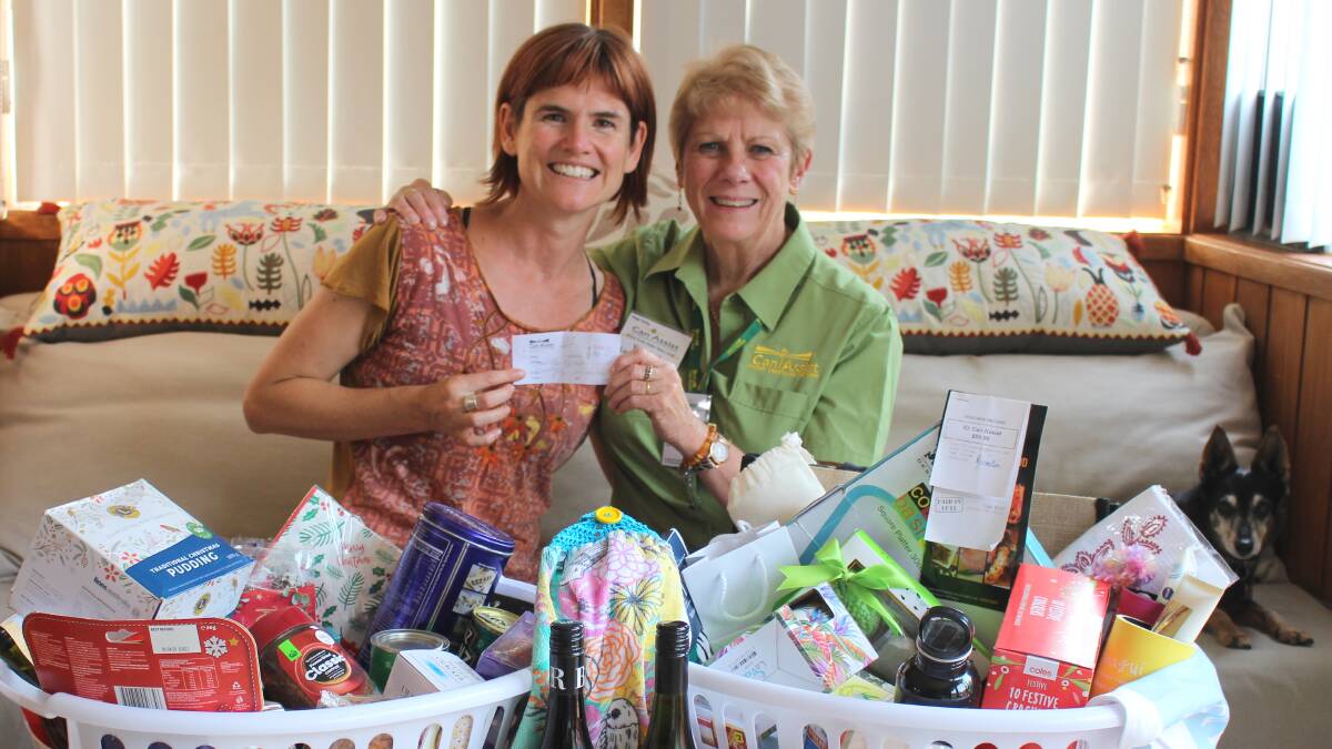 Winner of the Can Assist raffle Brooke Hutchins is congratulated by Lori Hammerton.