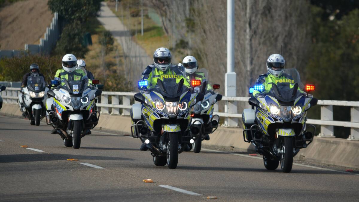 Police bikes lead a group of around 300 riders across the Bega Bridge on Saturday as part of the ninth annual Wall to Wall Remembrance Ride. Picture: Ben Smyth