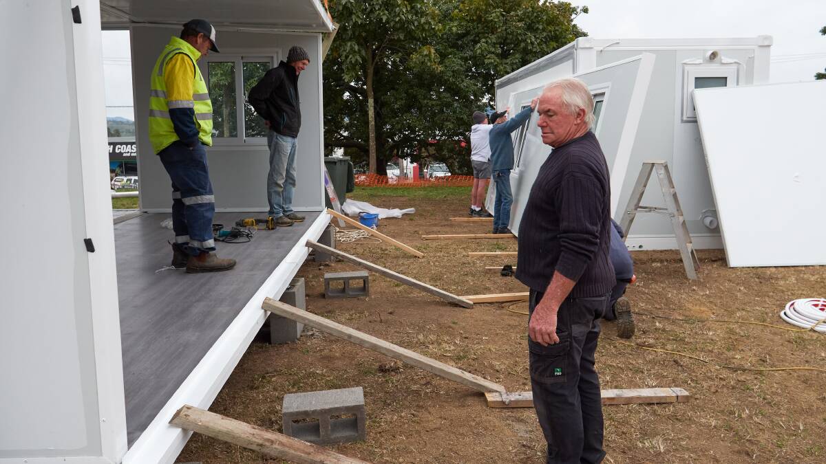 Bill Foxwell and other helping hands install temporary housing units at the Bega Uniting Church. Photo: David Howard