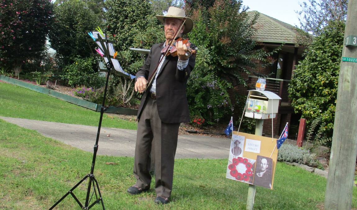 Cliff Tarrant of Beauty Point plays the Last Post on Anzac Day in his front yard.