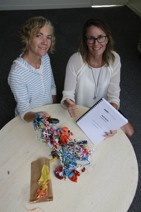 Eurobodalla Shire Council’s environment education officer Bernadette Davis and Mayor Liz Innes celebrate the ban of balloon releases at council events and council-managed reserves. They are pictured with balloon litter collected from the shire’s beaches, including one labelled promotional balloon found at Tomakin Cove in January, which travelled all the way from Alexandria in Sydney.