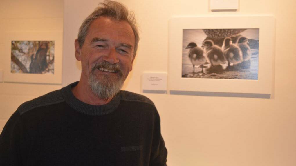 Eurobodalla Shire Greens councillor Patrick McGinlay at the 2018 Animals in the Wild exhibition with the winner of the 'most beautiful image of a bird in the wild', by photographer Amanda Bull.