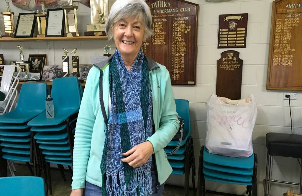 Jenny Ellis wears the scarf she wove during the workshop.