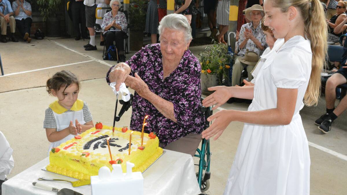GENERATIONS: Peyton Thompson and Hazel Ahkin, the youngest and oldest pupils of Candelo, cut the 150th birthday cake