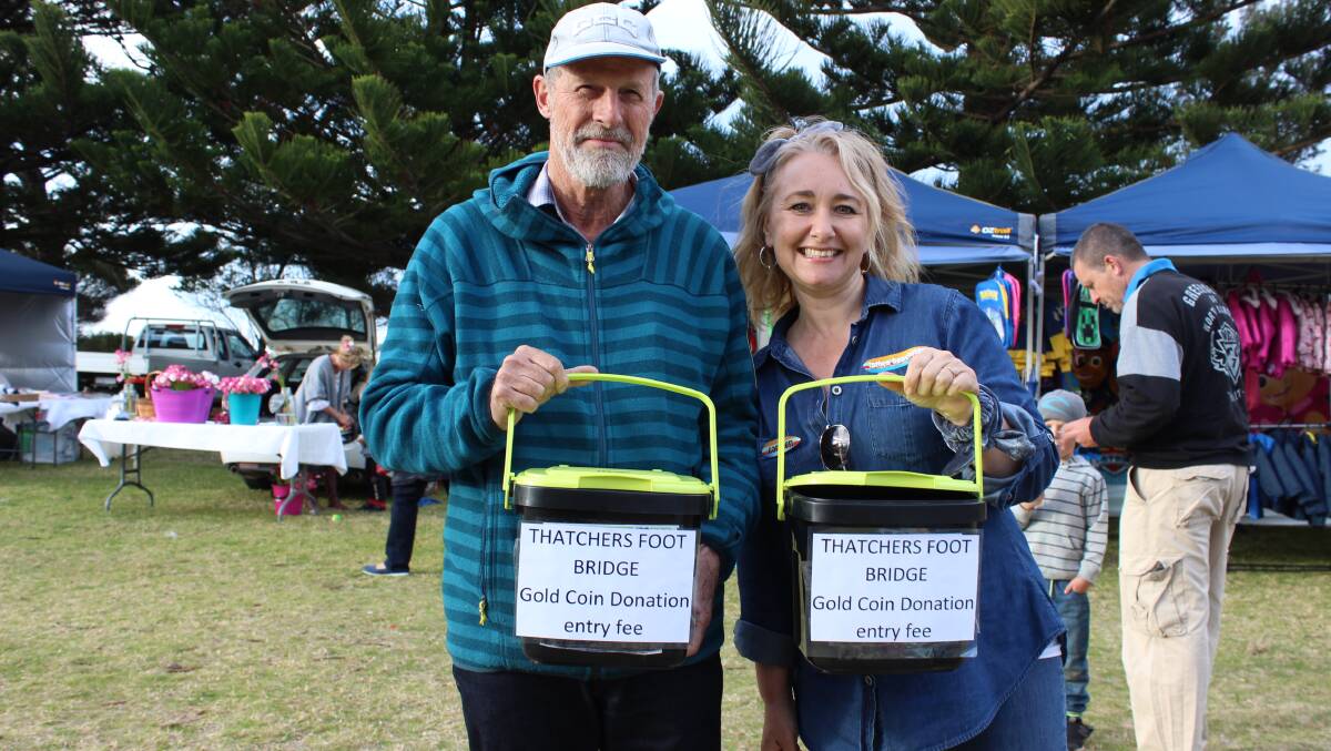 STEPS: Charlie Bloomfield and Carmen Risby take up a collection for the Thatcher's Flat footbridge during Tathra's Twilight Market on Saturday.