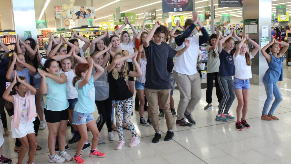 WHOLE NEW WORLD: The young cast of Spectrum Theatre's upcoming production of Aladdin Jr perform a sampler of their show with a flash mob in Bega. Picture: Ben Smyth