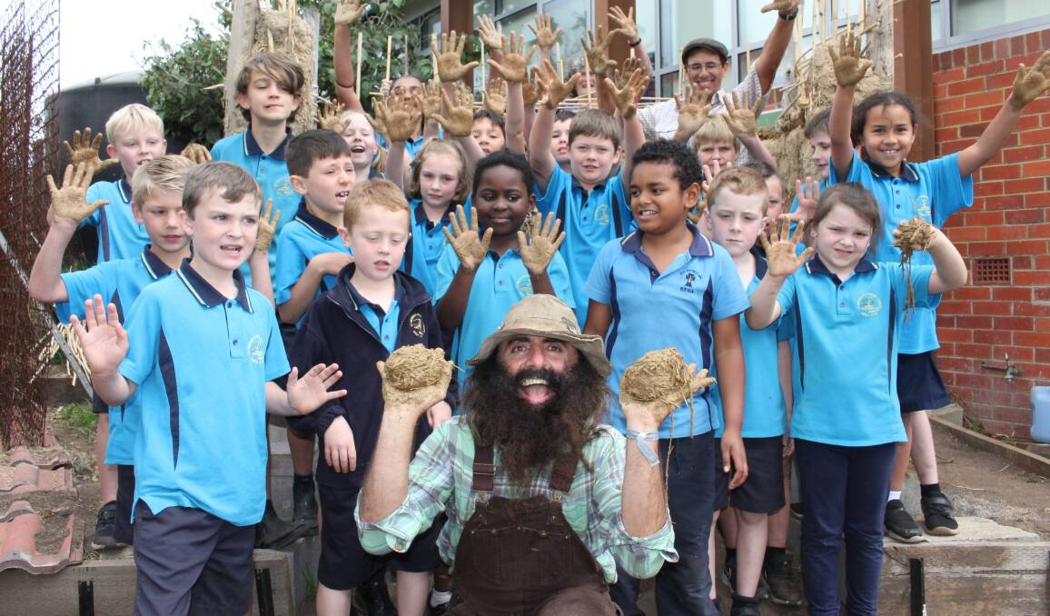 Costa meets the kids at St Pat's Bega to help build a wattle and daub chook palace during his tour of the South East last week. 
