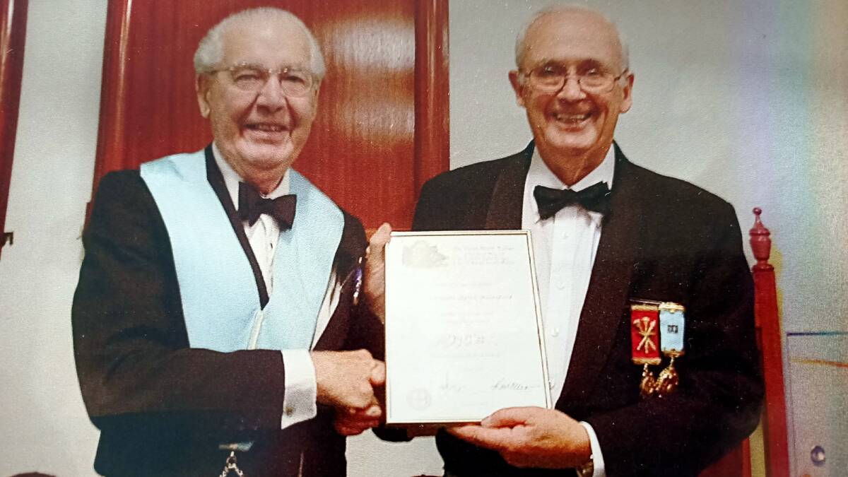 Keith Beresford (right) is presented with a certificate and jewel for 60 years as a member of the Freemasons, by senior member Dick Bird. Photo: Supplied