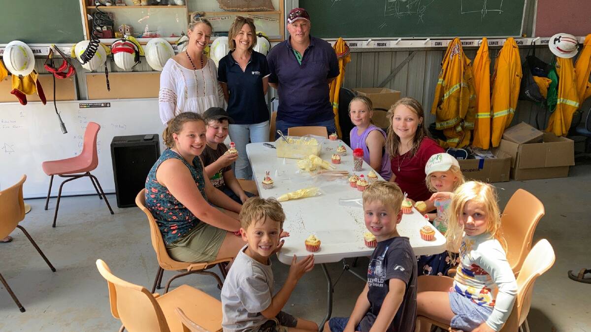 Cupcake decorating at a Fortem event at Tathra are Kelly Eastwood (Eastwood's Deli and Cooking School), Hayley Reynolds (Fortem Australia) and Adam Wiggins (Tathra RFS Captain) with their cupcake decorating champions.