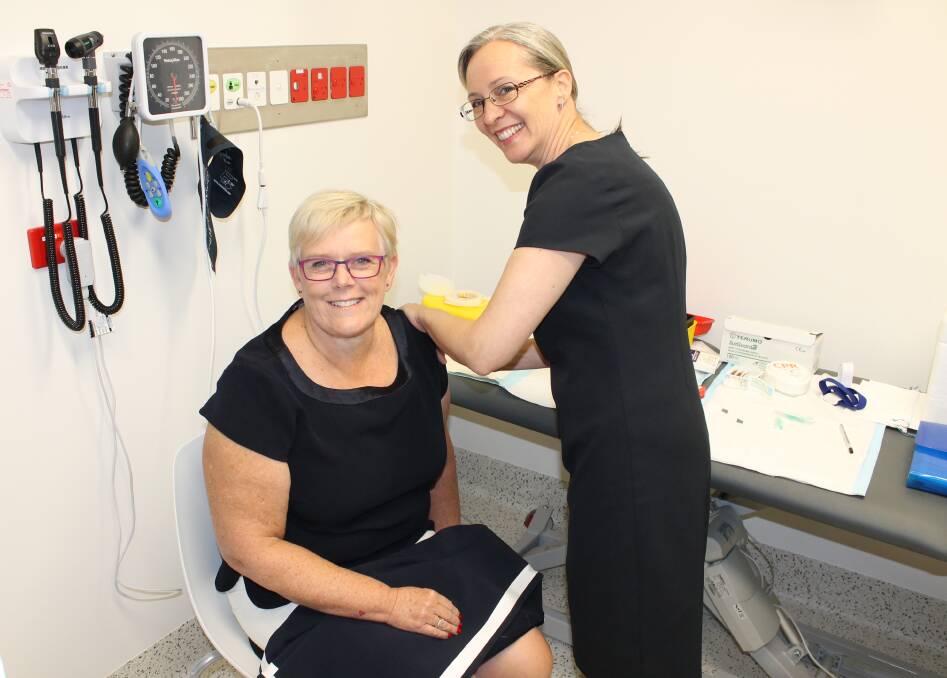 PREVENTION: New Southern NSW Local Health District chief executive Janet Compton gets her flu vaccination from Kelly Row at the SERH. Picture: Ben Smyth