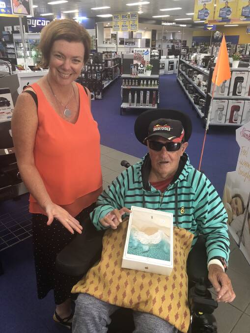 Robbie Maples purchases his iPad at Bega Betta Home Living with Kristi Sproates from Appy Connections.