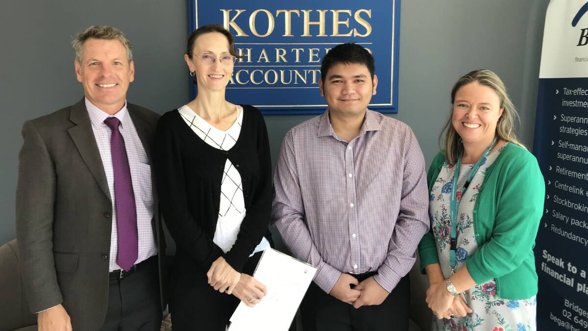 Gary Skelton from Kothes and Samantha Avitaia from Wollongong University (right) congratulate high-achieving accounting students Wendy Hodges and Jade Ferrer.
